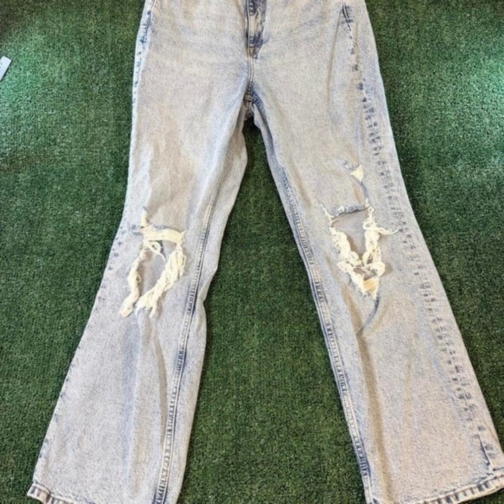 H&M Divided high-waisted distressed jeans in a light acid wash denim featuring